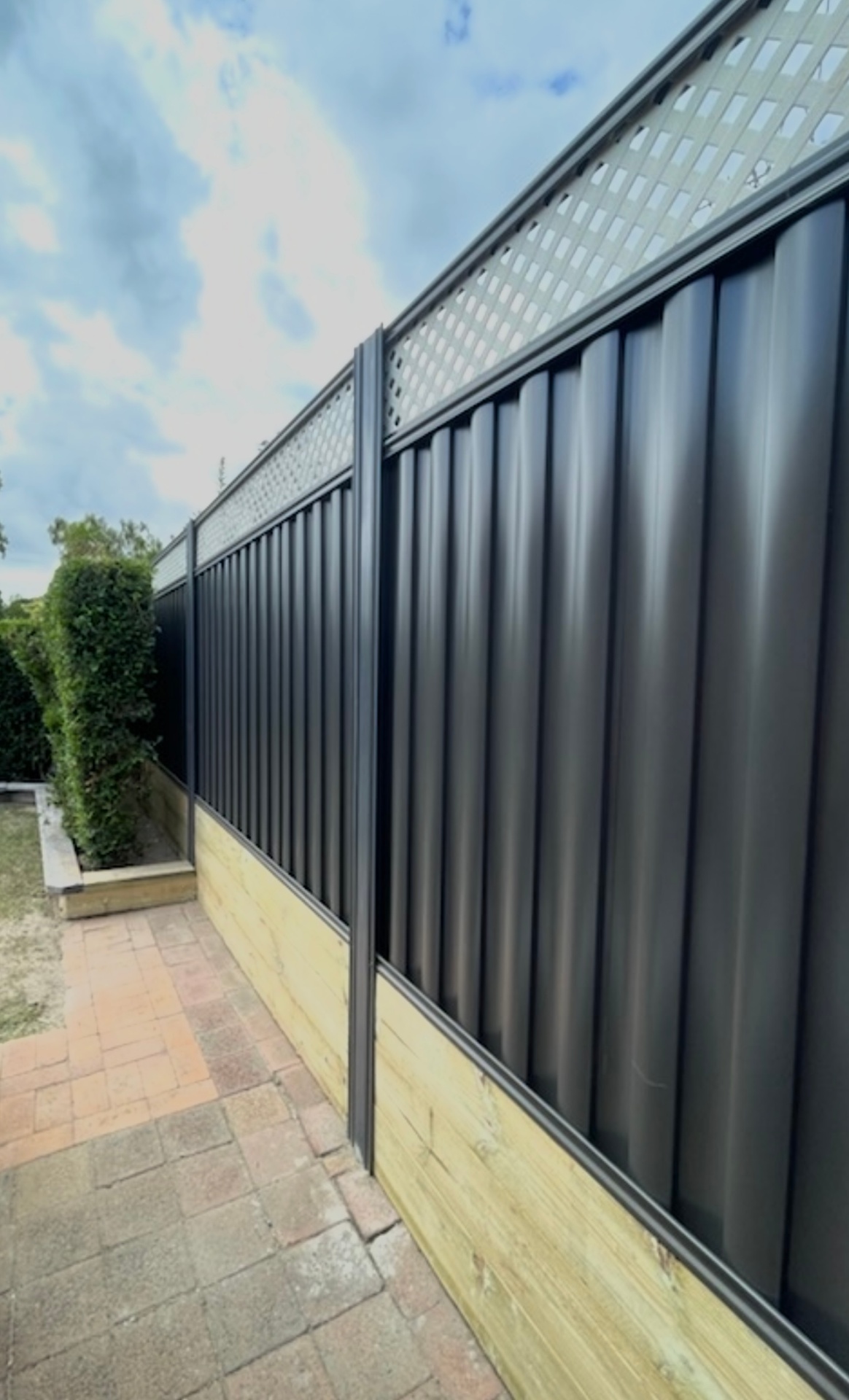Colorbond fence with lattice toppers and treated pine sleeper plinth
